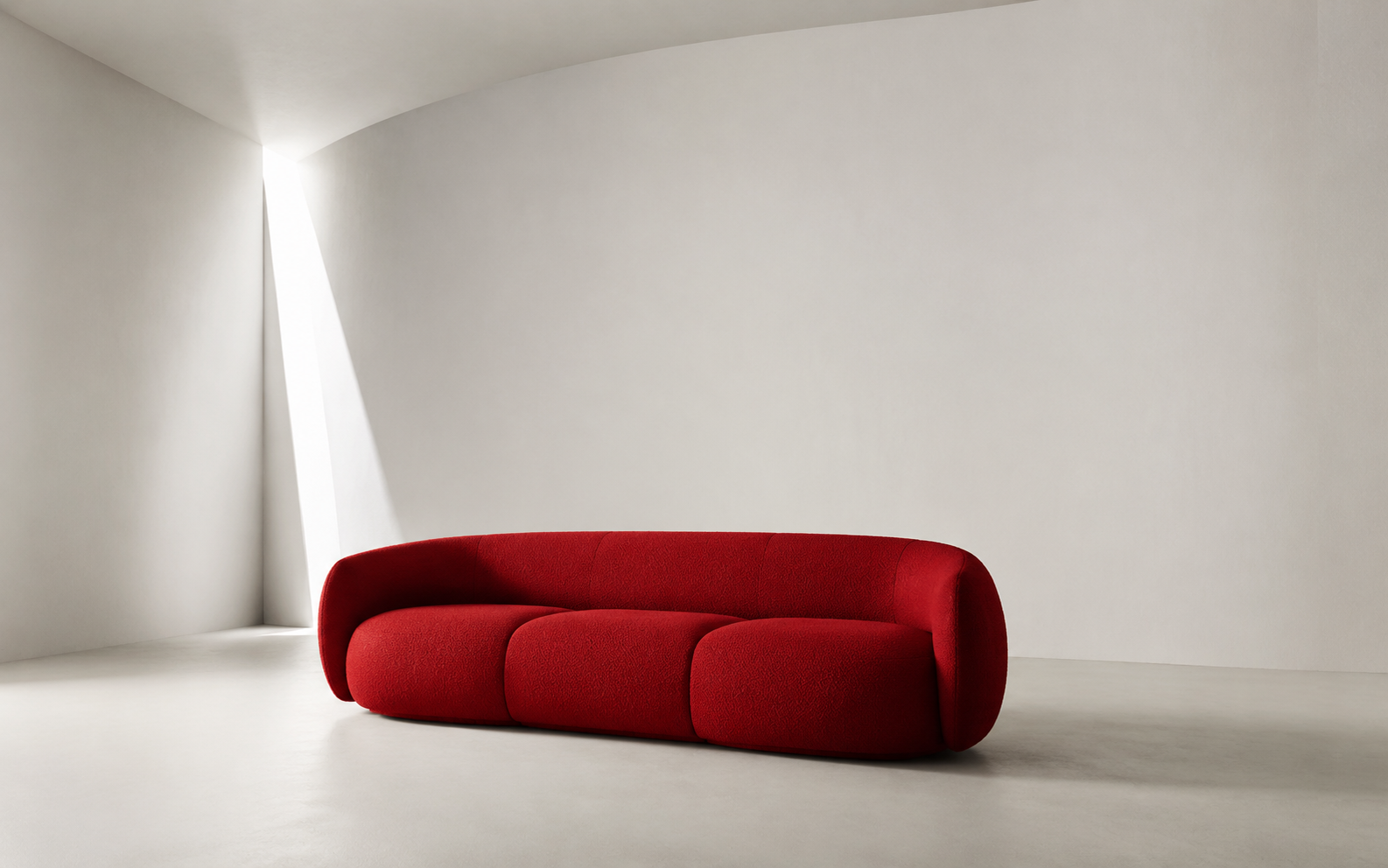 Sculptural red contemporary sofa in a minimal white gallery
